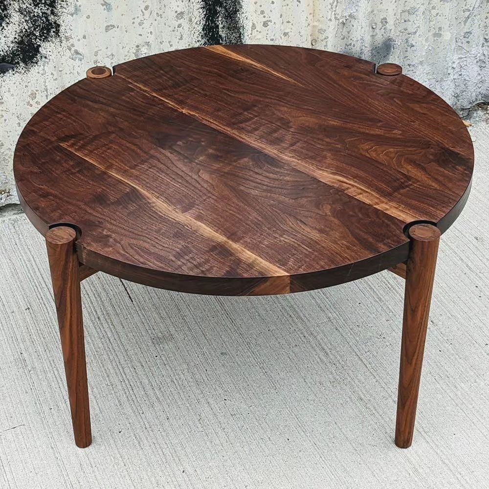 August 9th, 2023: This modern walnut coffee table features a unique circular top that appears to float above its supports.